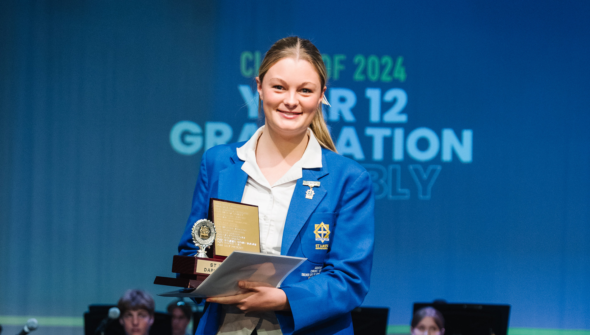 Lilly receives an award at graduation.