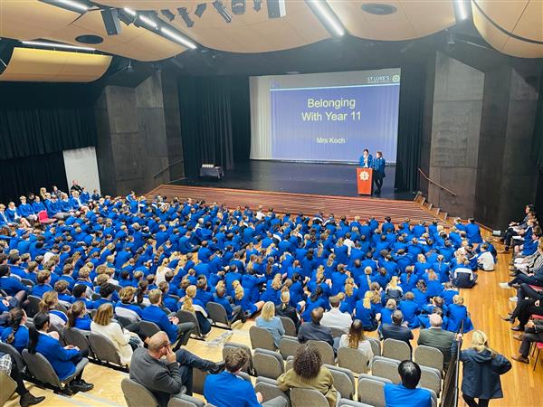 Girls giving a speech in assembly.